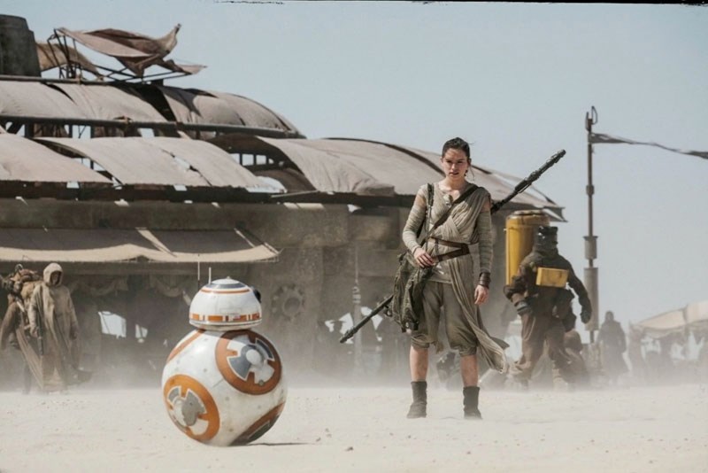 Rey (Daisy Ridley) meets BB-8 and sets off for adventure in Star Wars: The Force Awakens.
