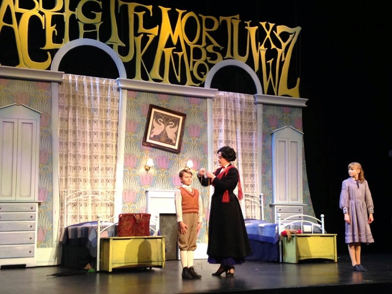 Mary Poppins (Gianna Read) takes Michael&#8217;s (Ethan Stang) measurements while Jane (Anna Johnson) waits her turn. The musical plays at Festival Place until Dec. 30.