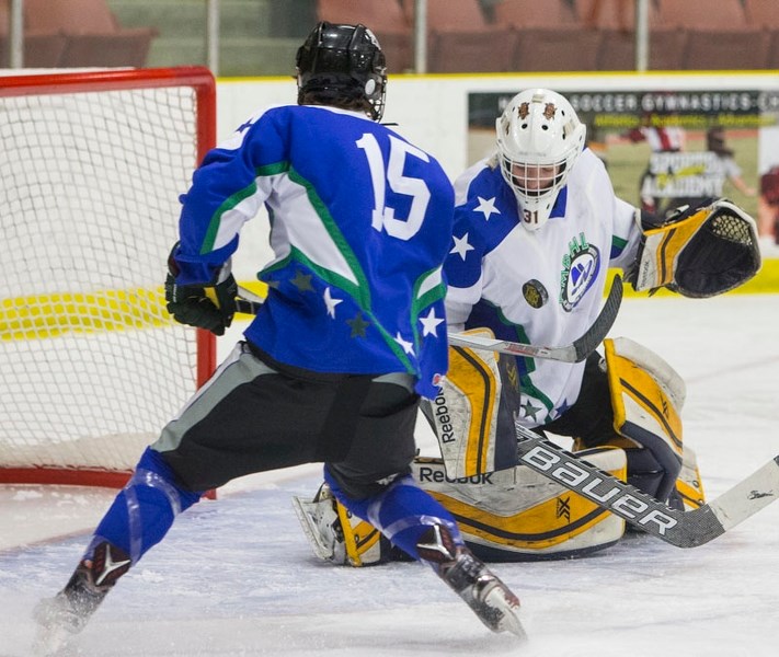 STARS ON ICE â€“ North all-star goalie Ryley Osland of the St. Albert Gregg Distributors Sabres stops a shot by south all-star forward Tarun Fizer of the Rocky Mountain