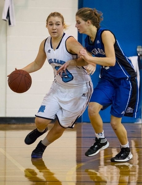 MAKING A MOVE â€“ Ashley Thomas of the Paul Kane Blues works the ball against a defender from the Catholic Central Cougars of Lethbridge in Friday&#8217;s tournament opener
