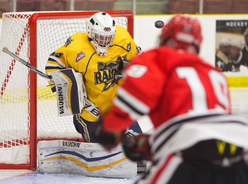 NET GUARDIAN &#8211; Evan Fradette of the St. Albert Gregg Distributors Sabres reacts to a shot by Ben Croasdale of the North Shore Winter Club Winterhawks at the John Reid