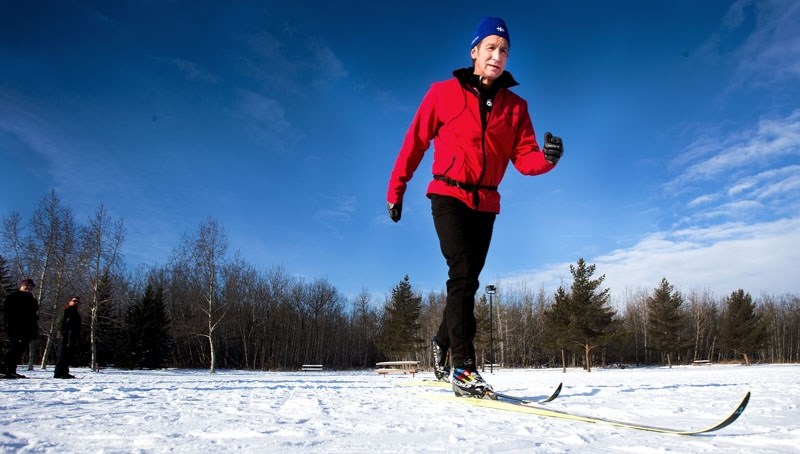Instructor Ken Burgess demonstrates a technique for students at the Red Willow Park during a beginners course put on by the Nordic Ski Club.