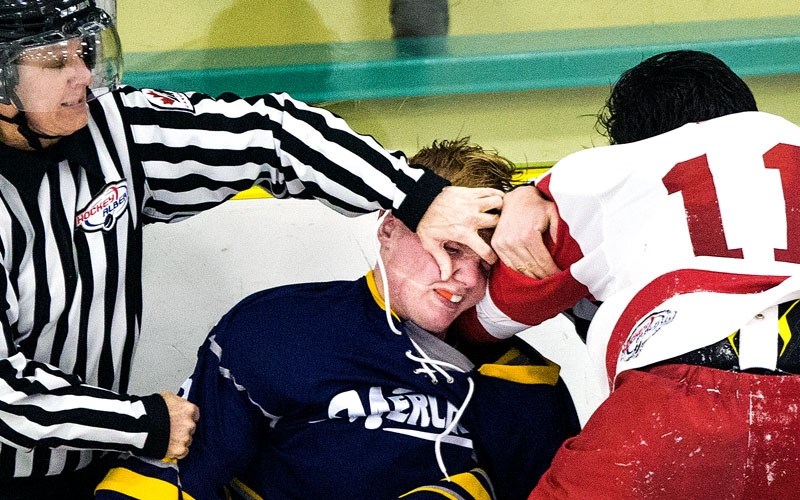NASTY BUSINESS &#8211; Linesman Arron Best moves in to separate Mitchell Walters of the St. Albert Merchants and Sine Chadi of the North Edmonton Red Wings during a