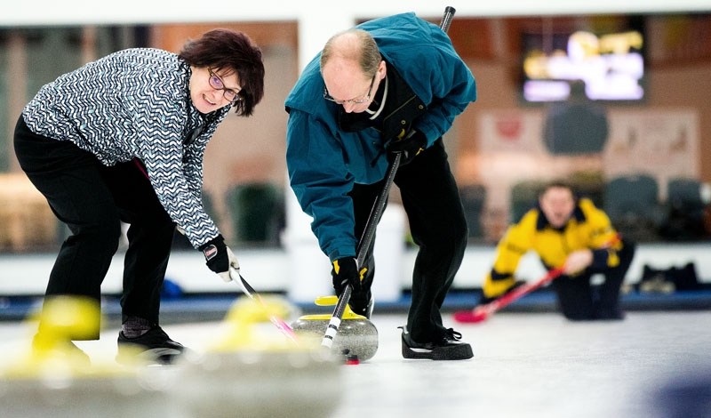 TEAMWORK &#8211; Rica Caron and Neil McKay drag skip Ferd Caron&#8217;s rock toward the house in Sunday&#8217;s A final at the Solo Liquor Stores Mixed Bonspiel at the St.