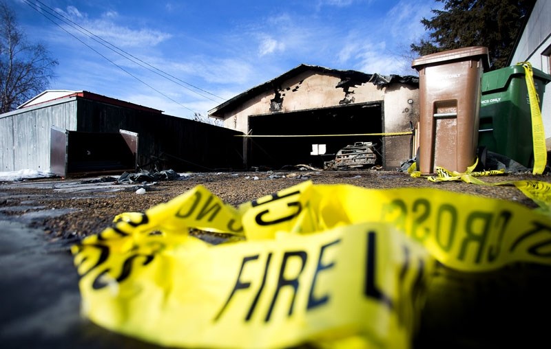 Fire tape scatters the ground near the scene of a garage fire that occured in the early hours of Wednesday morning