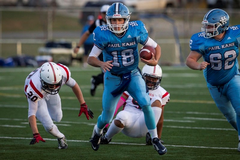 PROTECTOR &#8211; Offensive guard Jake Parent (62) rides shotgun during a quarterback run by Brendan Guy of the Paul Kane Blues in metro Edmonton division one football.