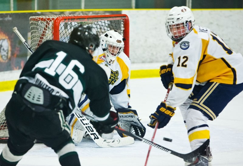 GOING FOR GOAL &#8211; Netminder Evan Fradette and defenceman Aidan West of the St. Albert Gregg Distributors Sabres react to a shot by Carter Chorney of the Sherwood Park