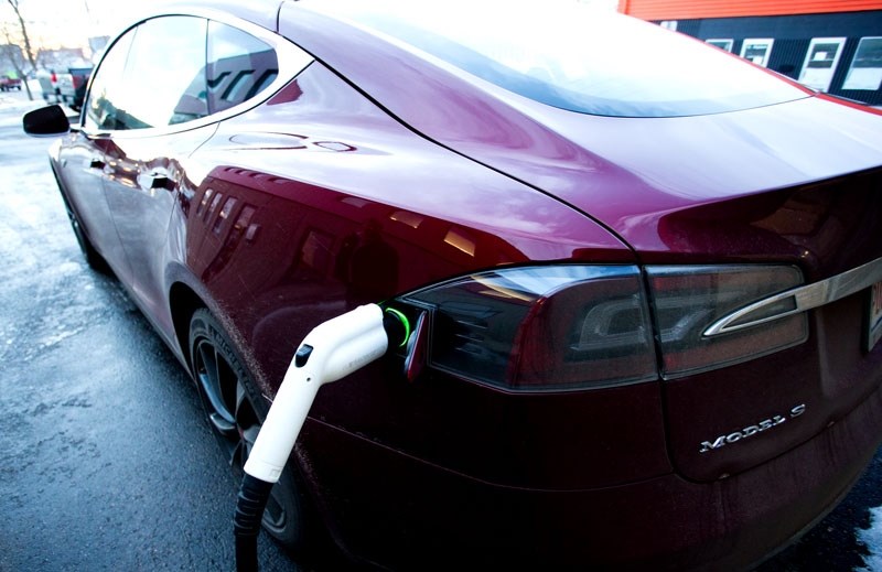 SPARK OF AN IDEA? â€” A Tesla Model S electric car charges up using a solar-powered electric charging station in the Riel Business Park. City council recently heard a pitch