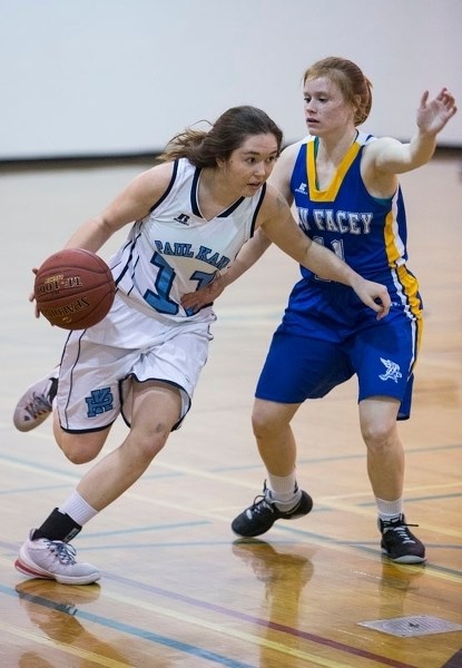 DRIVING &#8211; Alesha Stanley of the Paul Kane Blues powers past a Bev Facey defender in Monday&#8217;s metro Edmonton division one game at Paul Kane High School. The Blues