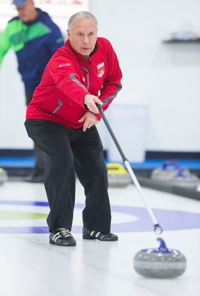 STICK MAN &#8211; Lorne Anheliger pushes the rock forward in the Drayden Insurance Stick Bonspiel on Saturday at the St. Albert Curling Club. The two-day competition featured 
