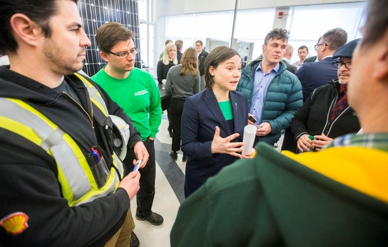 Environment and Parks Minister Shannon Phillips talks with a crowd at the unveiling of a $5-million renewable energy plan to create jobs and entice municiplaities and farms