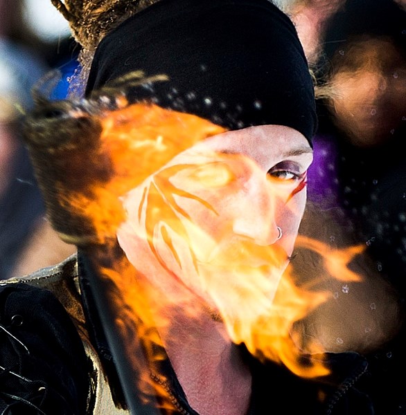 Kurt Couper of Fable Entertainment looks through the fire during a performance at the Fire and Ice family day festivities at Lacombe Lake Park on Monday.