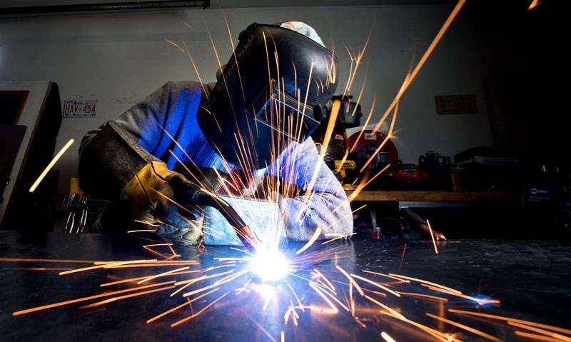 Artist Joanne Guthrie welds one of her artistic furniture projects last month.