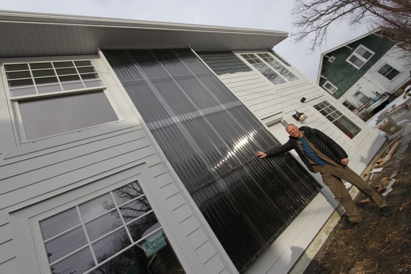 LIGHT WALL â€“ Godo Stoyke of Carbon Busters points out the solar wall at Edmonton&#8217;s first net-zero laneway house. The wall uses the greenhouse effect to heat air which 