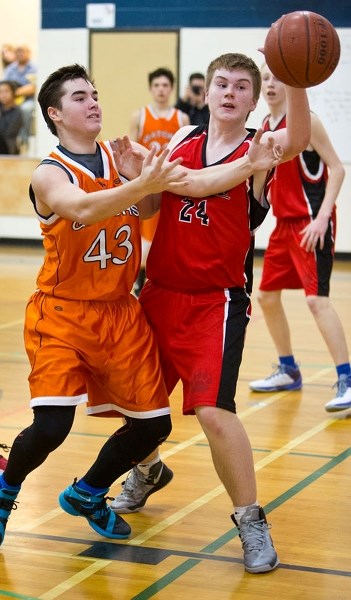 UP FOR GRABS â€“ Nolan Biesinger (43) of the Lorne Akins Gators and Matthew Cassidy of the Sir George Simpson Voyageurs reach for the ball in Tuesday&#8217;s 36-31 win for