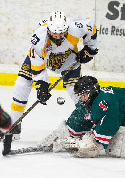 SCORING CHANCE â€“ Ethan McKinley of the St. Albert Gregg Distributors Sabres is locked in on the puck against netminder Mason Raimundo of the SSAC Southgate Lions in
