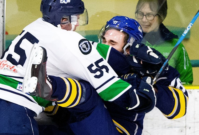 KNOCKDOWN â€“ Cam Mazur of the St. Albert Merchants is deposited into the boards by Joel Wentworth of the Edmonton Mustangs in game two in the best-of-five quarter-finals