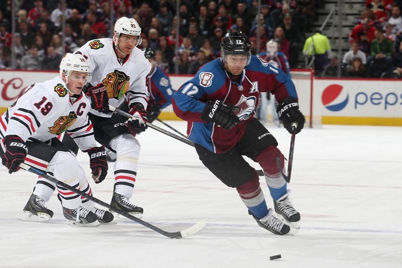 HOMETOWN HERO â€“ Jarome Iginla of St. Albert skates with the puck for the Colorado Avalanche against Jonathan Toews and Marian Hossa of the Chicago Blackhawks in NHL action