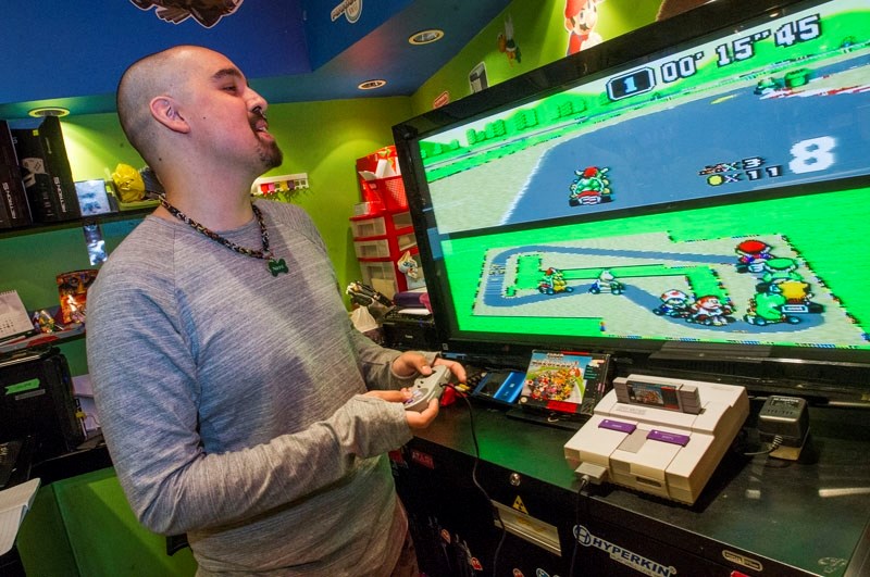 Game City&#8217;s general manager Terry Duncan gets in a round of Super Mario Cart on the Super NES console by Nintendo.