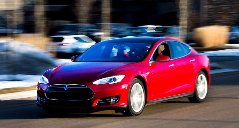 ELECTRIC VROOM â€“ Tesla owner Andrew Batiuk drives his Model S along Carleton Drive on Thursday morning. Batiuk says he now spends about a fifth as much money on his daily