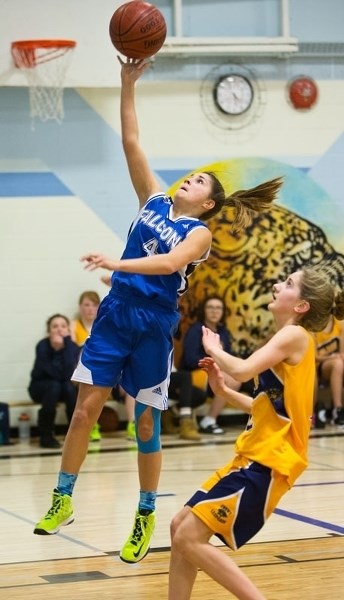 REACH FOR THE TOP â€“ Teagan Gomes deposits a layup for the Richard S. Fowler Falcons against the ESSMY Leopards in the SAPEC junior high basketball league. The Falcons are