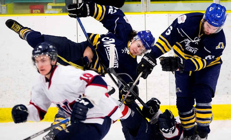 TRIPPED UP â€“ Matt Havens of the St. Albert Merchants is upended by the Wetaskiwin Icemen as teammate Steve Knoblauch feels the brunt of the collision in Wednesday&#8217;s