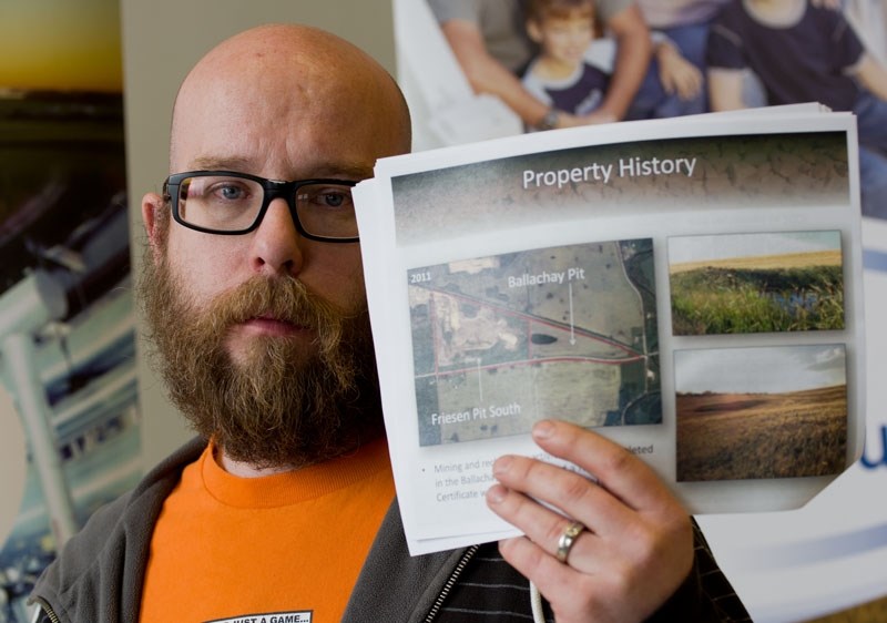 &quot;ENOUGH IS ENOUGH&quot; â€“ Sturgeon County resident Louis BĂ©langer displays a picture of the Friesen Pit