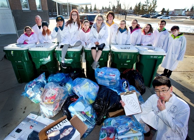 TRASHMONAUTS â€“ Reporter Kevin Ma scrutinizes this load of waste along with Morinville Community High School&#8217;s elite trash research squad in late February. The team