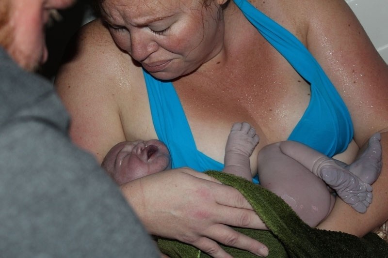 Midwife patient Lisa Brown poses with her newborn.