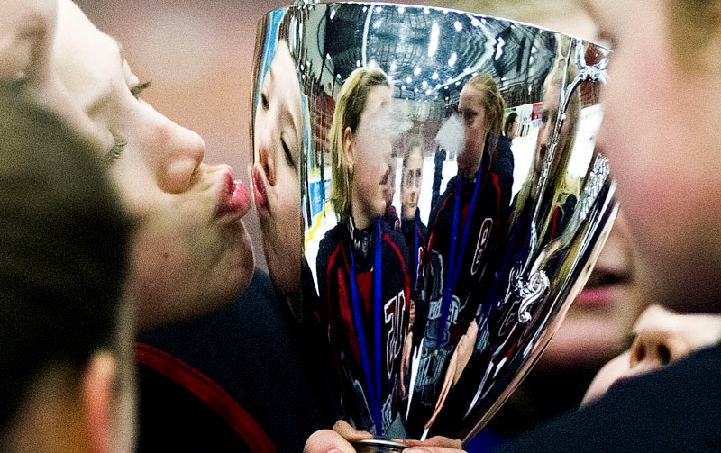 KISS OF CHAMPIONS â€“ Bridget Maxwell puckers up to kiss the Ringette Alberta championship cup