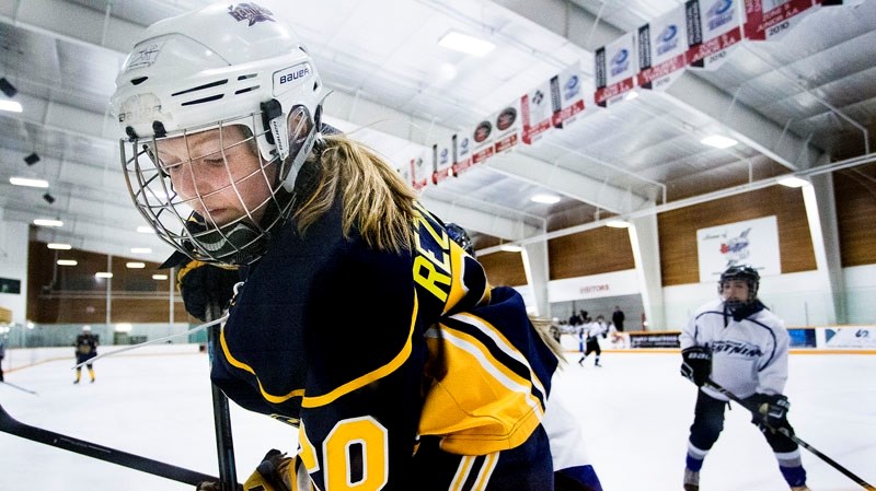 PLAYOFF ACTION â€“ Elleson Rezewski of the St. Albert Lady Raiders works for the puck along the boards in last weekend&#8217;s playoff game against the Edmonton Lightning at