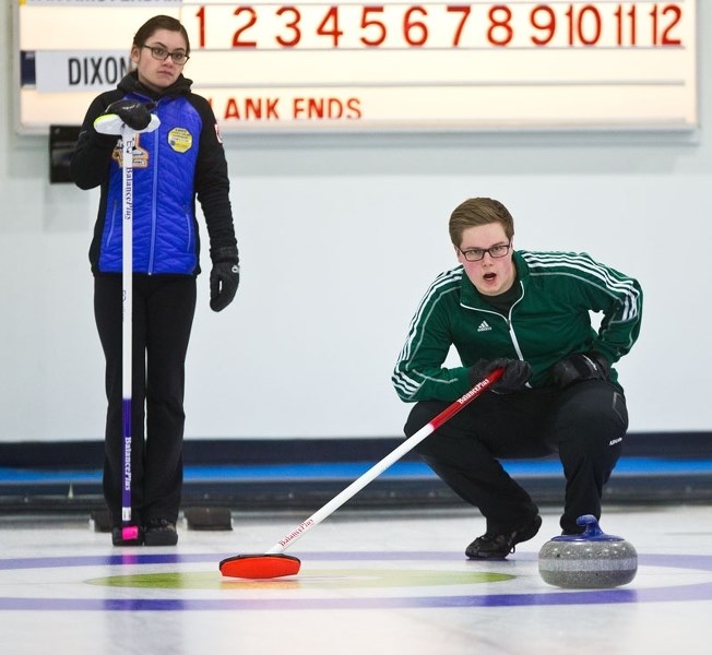 SKIPPERS â€“ Evan Van Amsterdam of Edmonton crouches in the rings as Kelsey Dixon of Calgary looks on during the first end of Sunday&#8217;s competitive final at the Marc