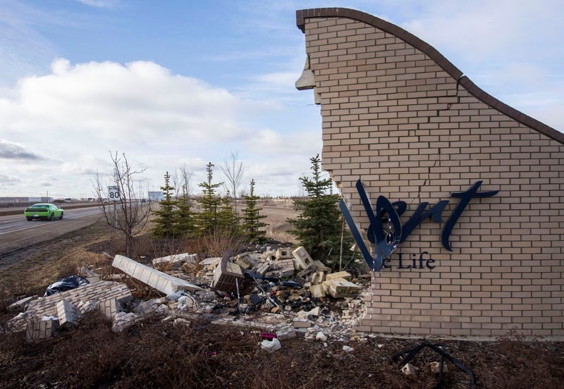 HARSH WELCOME â€“ The north-side welcome sign to St. Albert lies in ruins Thursday after a 34-year-old Morinville resident crashed into it with her car. The woman was taken
