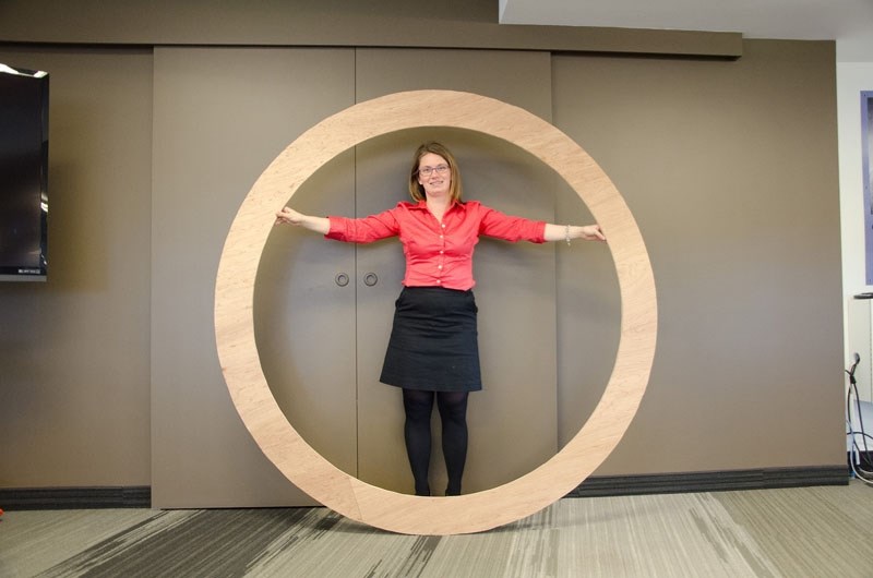 City engineer Kate Polkovsky demonstrates the interior size of the pipe to be used for the Project 9 trunk sewer project. The width of the pipe walls is yet to be determined.