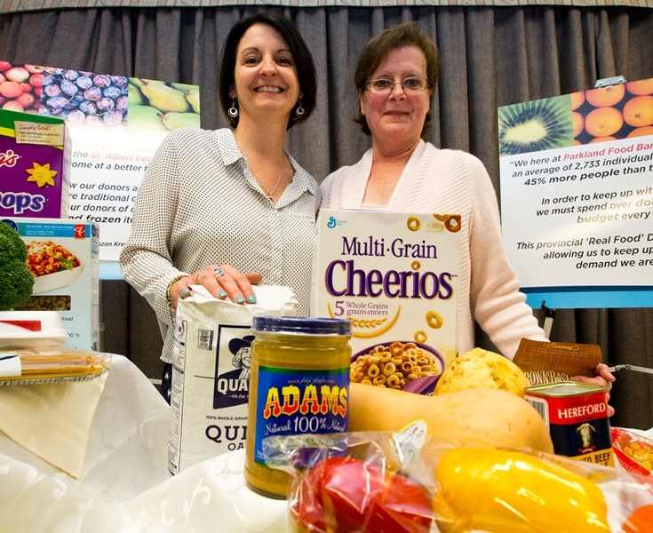 Stephanie Rigby of Alberta Food Banks and Suzan Krecsy of the St. Albert Food Bank announce the new Amp Your Good food drive during a press conference on Thursday.