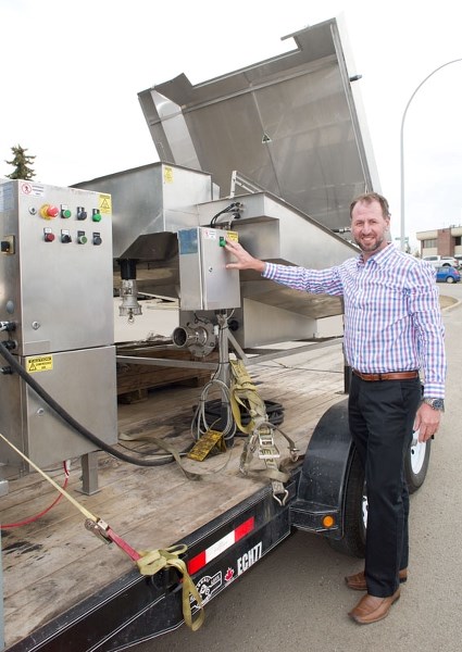FILTER TECH â€” Baleen International president David Dooley leans against one of his company&#8217;s portable wastewater filtration systems. Dooley believes his product could 