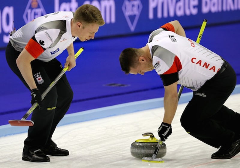 ROCK ON &#8211; Marc Kennedy (left) of St. Albert provides vocal support as Ben Hebert sweeps a rock for Team Canada at the men&#8217;s world curling championship in Basel