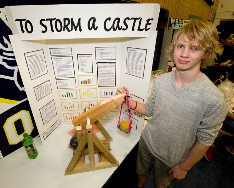 FETCHEZ LA VACHE â€” Sir George Simpson student Alec Tinga explains the mechanics of a trebuchet as part of his entry into last weekend&#8217;s Edmonton Regional Science