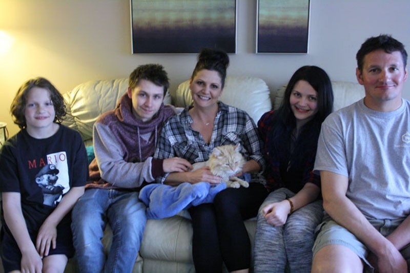 The Abbott family is delighted their cat came back after a six-month absence. Left to right are Roman