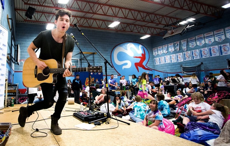 RIDE ON â€“ Local singer Paul Woida performs for a group of VJM students during the school&#8217;s Cyclebetes event on Thursday. Now in its fifth year