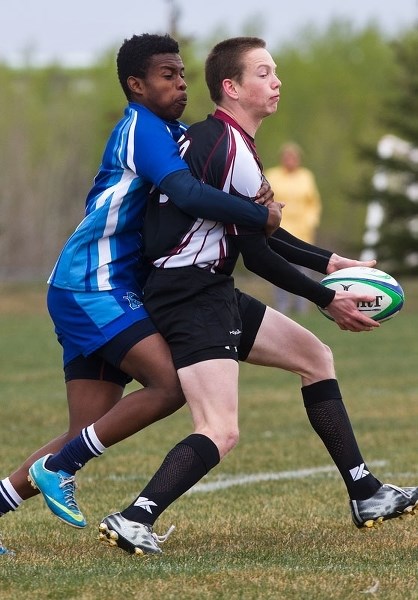 GOTCHA â€“ Austin Mazzolini-Flynn of the Bellerose Bulldogs looks to distribute the ball while in the grasp of Mo Munye of the Paul Kane Blues in Saturday&#8217;s exhibition