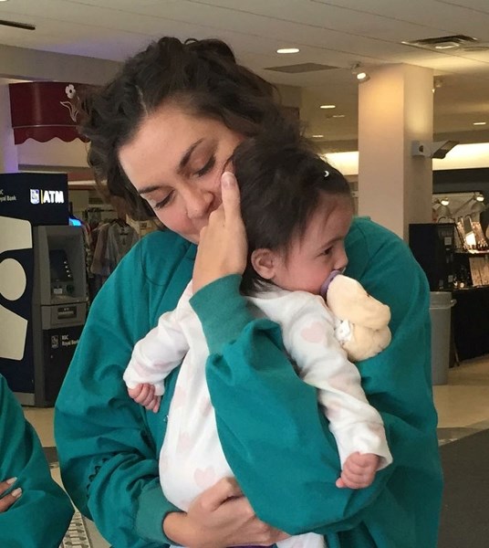 Baby Eleanor is reunited with Misercordia neonatal intensive care unit nurse Lisa Sydora-Wood as parents Natalie and Richy Trinh dropped off bagsfull of clothing