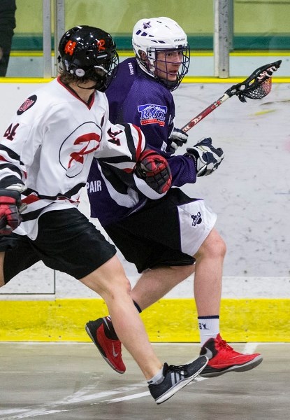 RUNNING THE FLOOR &#8211; Rory Sharon of the St. Albert Crude is pressured by Will Flink of the Fort Saskatchewan Rebels in Friday&#8217;s junior B Tier I season opener in