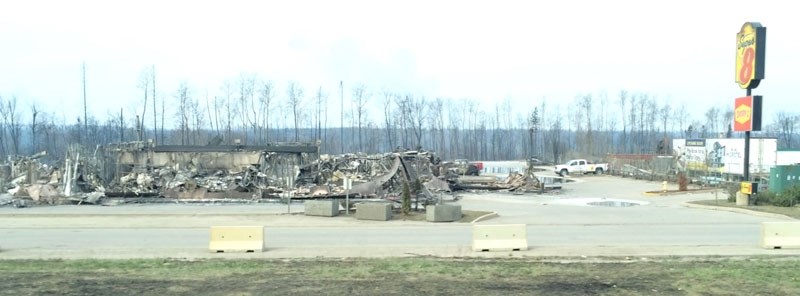 ASHES â€“ The remains of a Super 8 Motel alongside Hwy. 63 in Fort McMurray last Thursday. Simpson notes that many buildings in the city