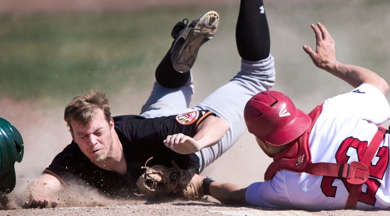 PLAY AT THE PLATE â€“ St. Albert Junior Cardinals catcher Scott Peterson tags a player at home plate in Sunday&#8217;s 6-1 loss to the Barrhead Orioles at Legion Memorial