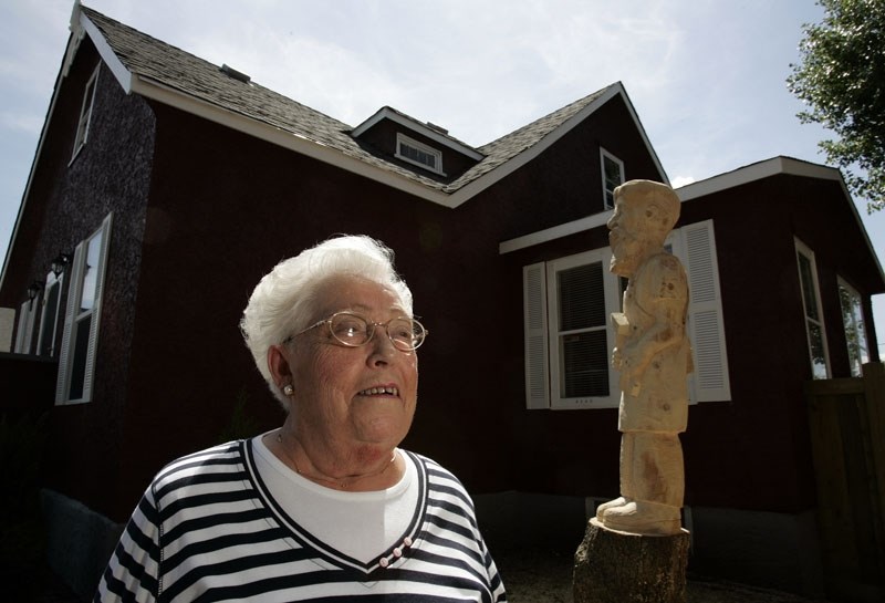 MORINVILLE&#8217;S HISTORIAN â€” Raymonde &quot;Rip&quot; Riopel stands with her childhood home (Perras Place) in downtown Morinville in this 2006 photo. Riopel died earlier