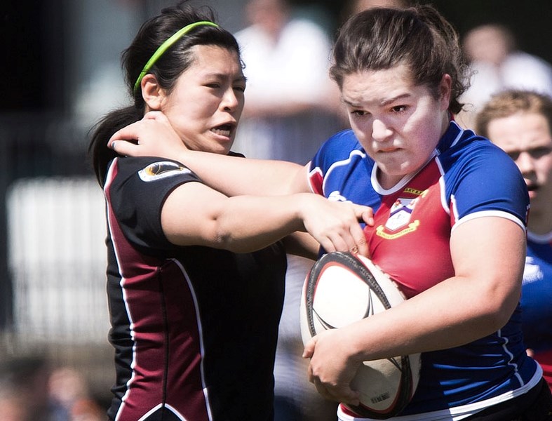 GET OUT OF MY WAY â€“ Kolby Krueger of St. Albert fights off Adrianna Chong of Crude/West in Saturday&#8217;s division one match at the Nor&#8217;Westers Rugby Park. St.
