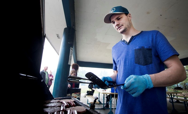Paul Clemens flips burgers during the Loseca BBQ in Lion&#8217;s Park on Thursday.