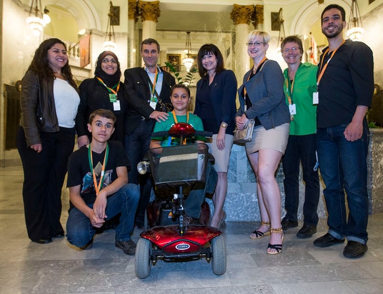Government sponsored refugees presented at the Alberta legislature. Back row
