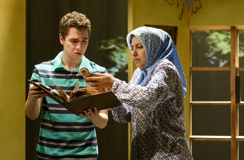In the world premiere of The Book of Ashes Amir (Aidan Burke) and Alia (Nimet Kanji) look in horror at an old manuscipt that burned in the bombing of Basra&#8217;s libarary.